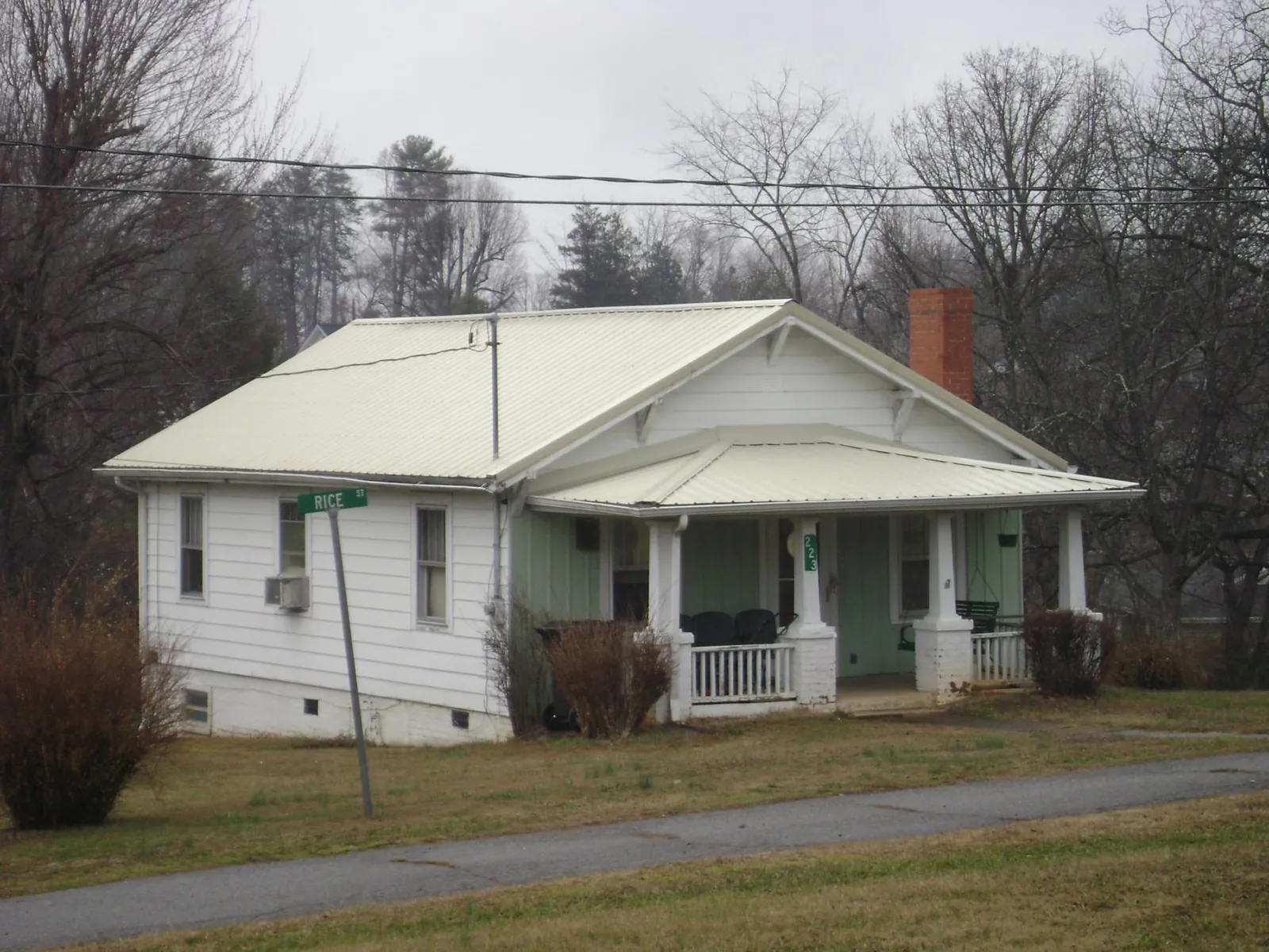 White metal roof on a craftsman bungalow at a street corner in Seward